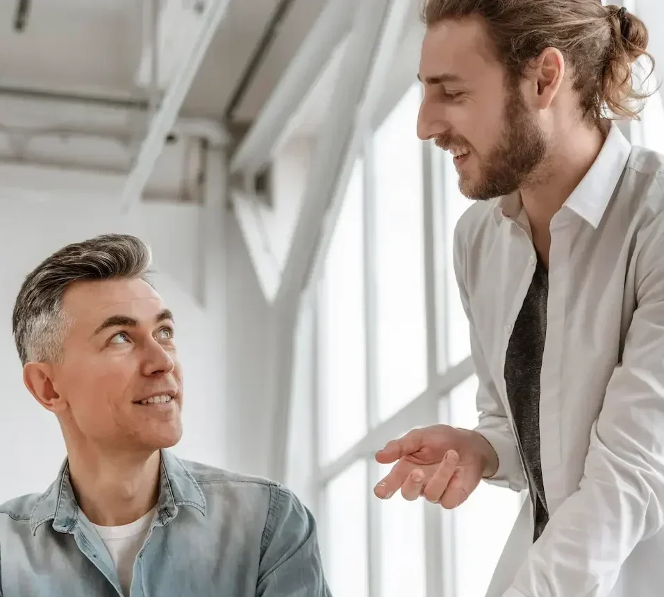 Two business professionals discussing ad strategy and marketing results